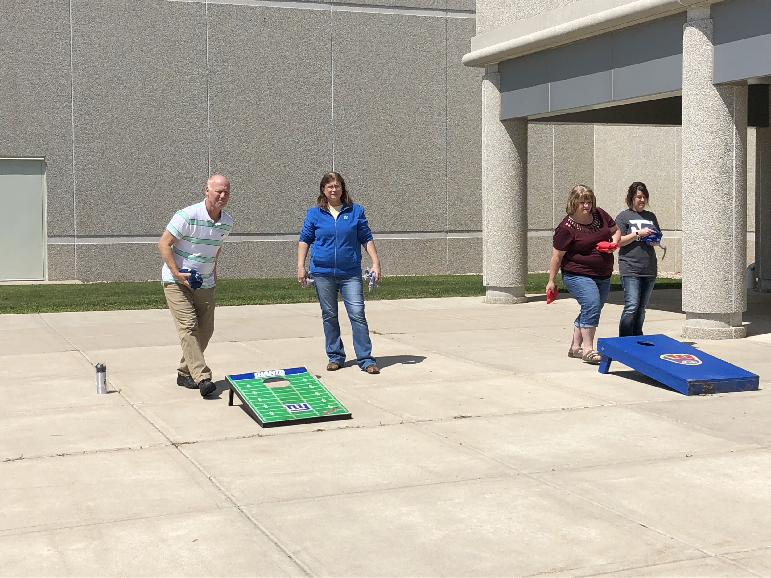 Employees playing a friendly game of bags